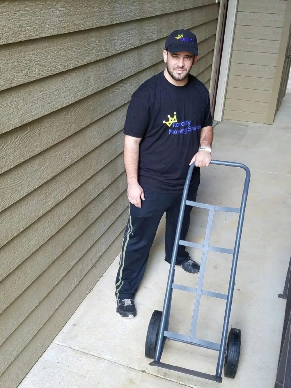 Royalty Moving crew member with a branded hand truck, ready for a Morrisville move