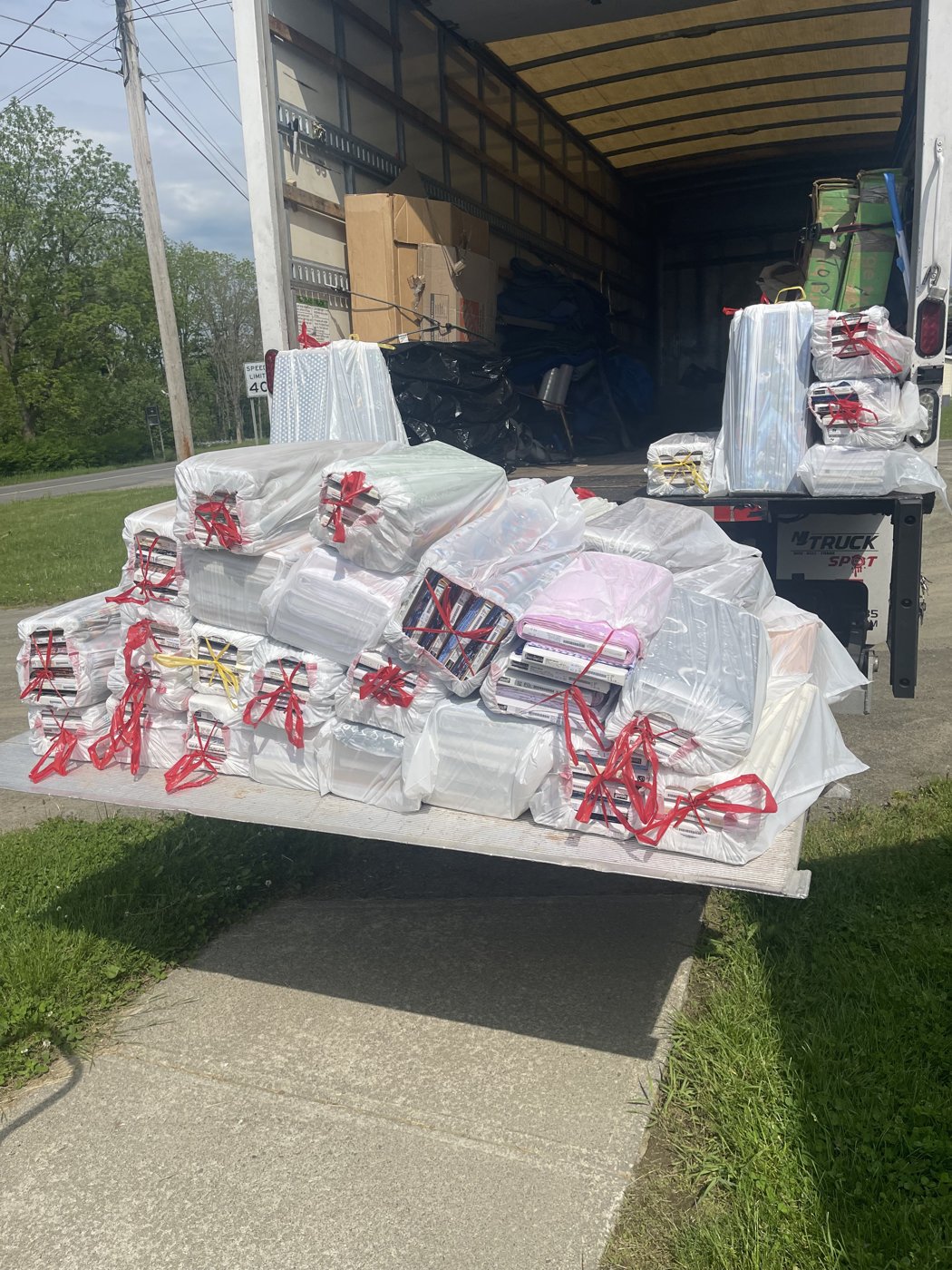 Business inventory individually wrapped, tagged, and staged on the Royalty Moving liftgate during a commercial move
