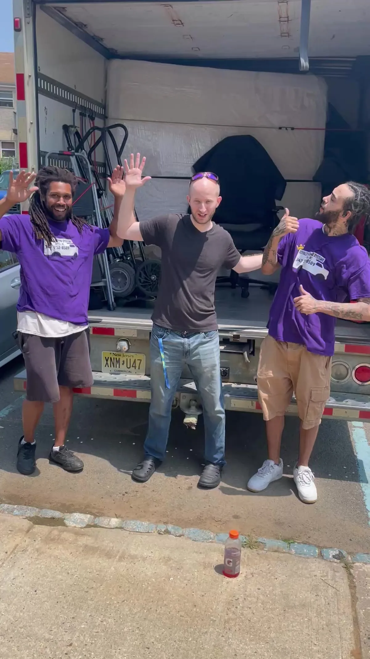 Royalty Moving crew and customers celebrating by the truck